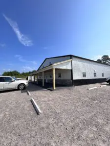 A building with a car parked in front of it