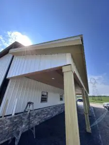 Side view of a wooden house with a porch in front