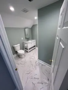 A newly furnished modern washroom with light colored interiors